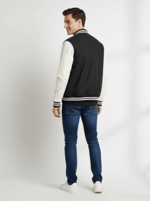 A black and white varsity vogue varsity jacket with white trim
